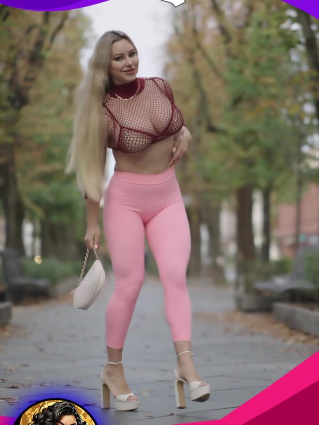 A woman in pink leggings and a pink top, exuding confidence and style